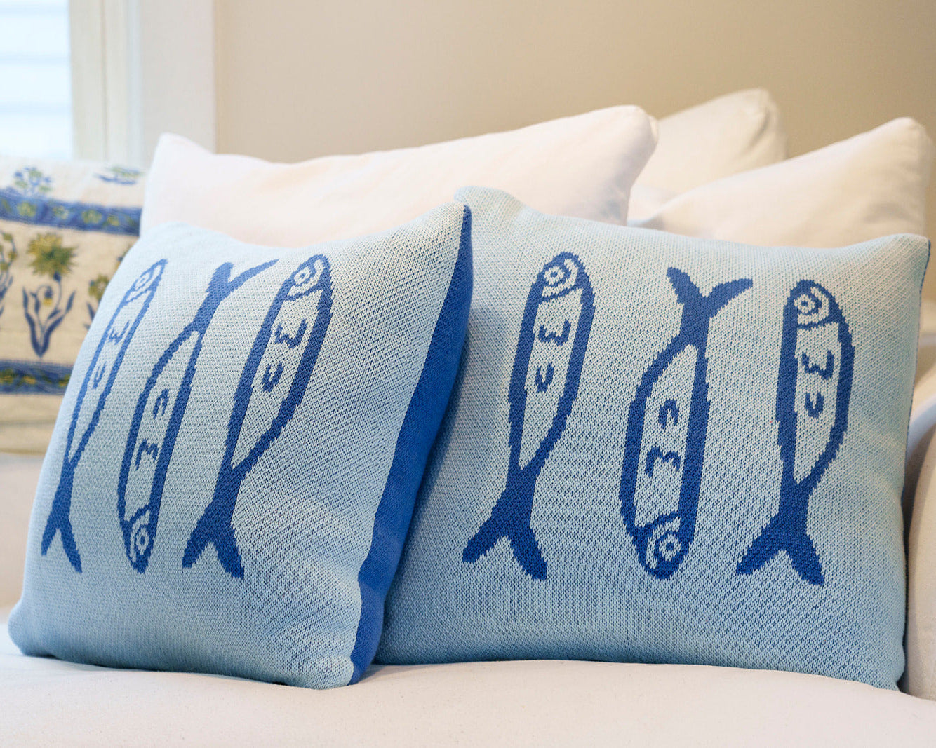 Decorative pillows with fish patterns on a couch